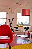 Classic design in loft apartment - red shell chair, arc lamp, elliptical table, cowhide chairs and coat stand