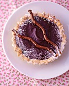 Chocolate tartlet dusted with icing sugar