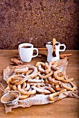 Churros with icing sugar and a chocolate dip