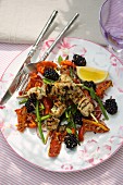 A salad of dried tomatoes, Thai asparagus and blackberries with pork skewers
