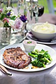 A rib-eye steak with broccoli florets served with a red wine and mustard dip with horseradish
