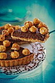 A slice of chocolate tart topped with popcorn