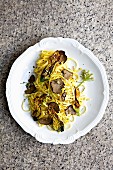Tagliatelle with truffle mushrooms and courgette flowers (seen from above)
