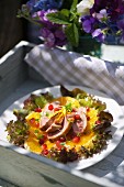Salad with roast duck breast, oranges and pomegranate seeds