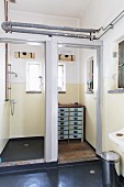 Shower cubicle and vintage chest of drawers in loft-apartment bathroom