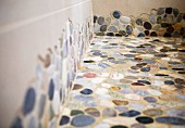Bathroom floor tiled with mosaic pebbles