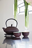 Cast-iron teapot and bowls on kitchen counter