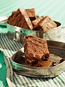 Brownies with butterscotch sauce in a tin for a picnic