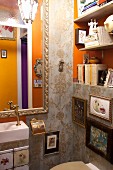 Opulent guest WC with ornamental wallpaper, Baroque mirror and gallery of pictures