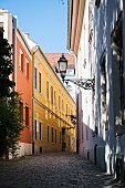 An empty cobbled alleyway with colourful houses in the Castle Quarter, Budapest, Hungary