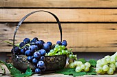 Red and green grapes in a metal basket