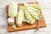 Fresh Chinese cabbage and salt on a chopping board