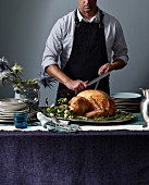 A man carving a roast turkey