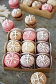 Macaroons iced with snowflakes in a gift box