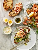 Grilled bread topped with prawns, cress and egg