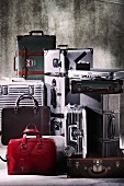 Various suitcases and bags arranged against grey background