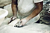 A baker kneading bread dough