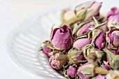 Dried rosebuds in white china bowl