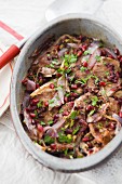 Pork with red onions and pomegranate seeds