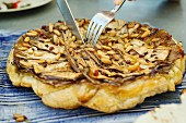 Aubergine tarte tatin with pine nuts and cocoa beans