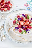 Pavlova with berries and violets