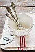 Porcelain cup with spoons on a tea towel