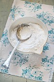 Icing sugar in a antique bowl with a spoon