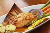 Salmon in maple syrup on a thin wooden sheet