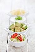 Various toppings: spring onions, chilli rings, avocado, cheese and sour cream
