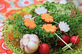 An Easter nest made from cress with carrots, radishes and garlic for an Easter breakfast