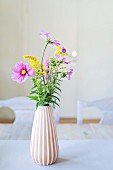 Garden flowers in vase with pleated structure