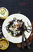 Squid pasta with red onions, pine nuts and Parmesan cheese