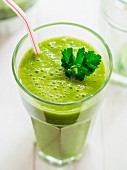 A gGreen smoothie garnished with parsley