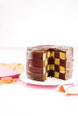 Cut mocha chessboard cake on cake stand