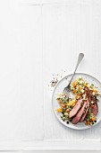 Lamb fillets with couscous, dried apricots and cucumber