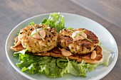Fried lobster cakes on a bed of lettuce