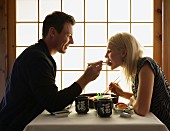 A couple eating sushi in a Japanese restaurant