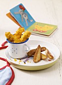 Breaded chicken goujons with potato wedges as baby food