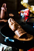 A chocolate Father Christmas being melted to be used for chocolate cake