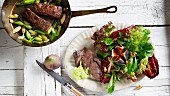 Roast lamb fillet with fresh figs on a mixed leaf salad