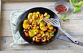 Fried potatoes and prawns with cherry tomatoes
