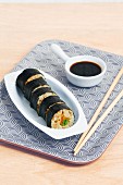 Maki sushi with vegetables and soy sauce