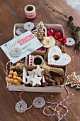 Various Christmas biscuits and Christmas decorations in an old box