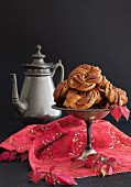 Chocolate and cinnamon buns on a pewter stand