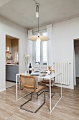 Small dining table and two cantilever, cane chairs