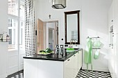 Modern kitchen in black and white colour scheme and pastel green accents