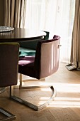 Upholstered cantilever chairs around table on parquet floor