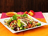Warm chicken salad with chilli peppers and cashews