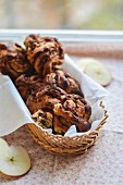 Almond and apple cakes with chocolate in a bread basket
