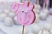 A pick pig biscuit on a stick